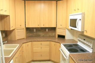 Kitchen includes dishwasher, range, microwave, refrigerator.
